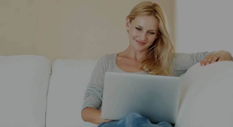 Woman using laptop on a couch